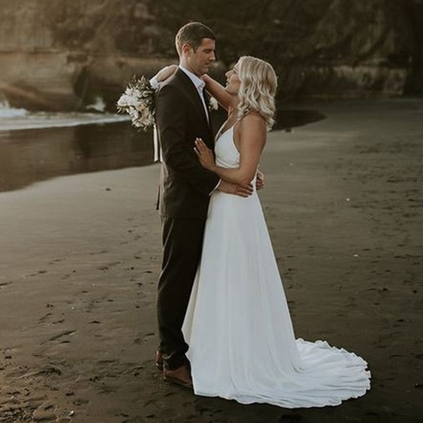 Feature-Jo-Mike-Daisy-Daffodil-wedding-dress-bride-groom-beach-sand-train